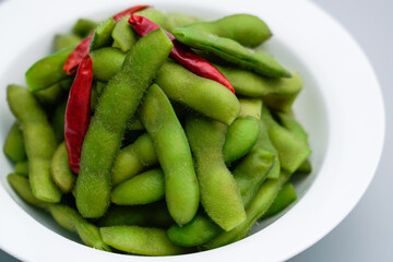 A traditional Chinese delicacy in solid color, boiled soybeans in brine. Chinese traditional food boiled soybean.