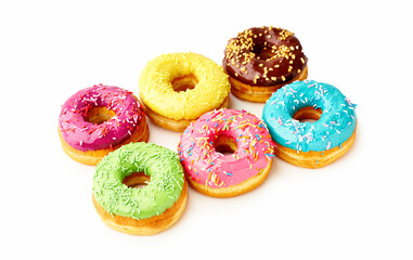 Fototapeta na wymiar Sweet colorful glazed doughnuts from above on white background. Junk food top view, sugar treat