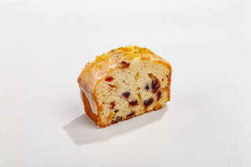 piece of cupcake with raisins and nuts on a white background