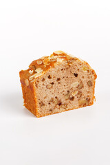piece of cupcake with raisins and nuts on a white background