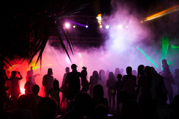 Fototapeta na wymiar Silhouette of people dancing in a disco