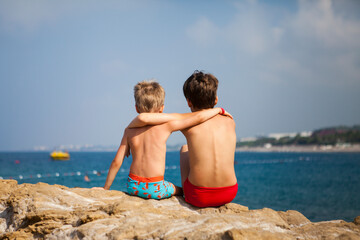 Brothers rest by the sea