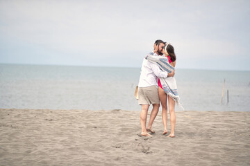.Young  couple is kissing and enjoying on the beach.