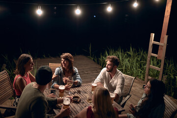 People drinks alcohol and having fun at summer evening