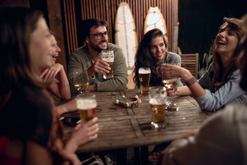 Friends having fun at an outside party. People enjoying drinks together.