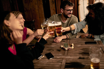 Young friends drinking beer and and having a good time. People having fun drinking alcoholic.