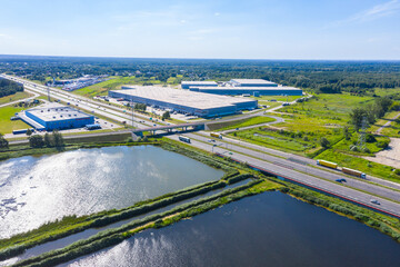 Aerial Shot of Industrial Loading Area where Many Trucks Are Unloading Merchandise.