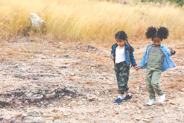 Children hiking in mountains or forest. Kids Camping summer. Two funny little girls having fun during forest hike on summer. Friend forever