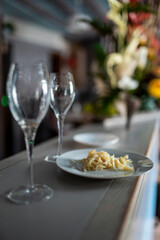 Cooked cod with two empty glasses