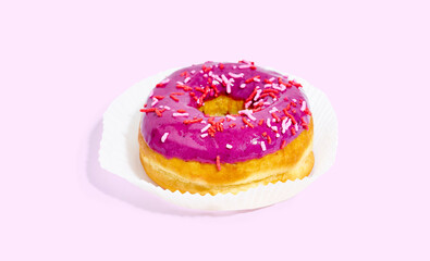 Sweet glazed purple doughnut isolated on colorful background