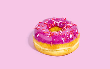 Sweet glazed purple doughnut isolated on colorful background