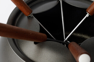 Metal cookware for fondue preparation on white