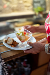 Someone take a piece of dessert on a plate