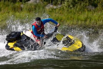 Man riding a wave runner in a river enjoying a nice summer day. © Wlad Go