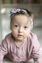 Cute baby girl with hairband (ribbon). Adorable child