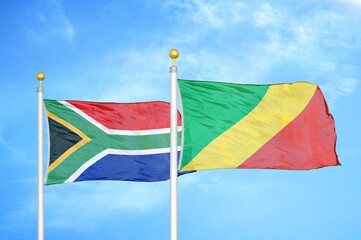 South Africa and Congo two flags on flagpoles and blue sky