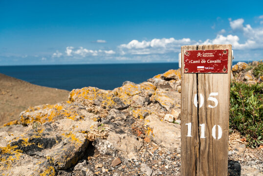 A wooden sign on the Cami de Cavalls (horses walk) coastal walk in Minorca island.