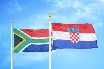 South Africa and Croatia two flags on flagpoles and blue sky