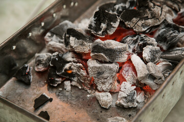 embers in a container for cooking barbecue