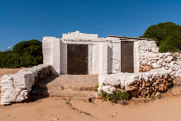 An old fisherman house on the Cami de Cavalls coastal walk in Minorca island.