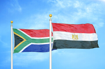 South Africa and Egypt two flags on flagpoles and blue sky