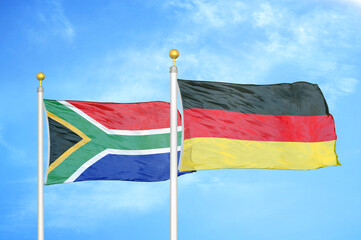 South Africa and Germany two flags on flagpoles and blue sky