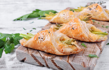 Green asparagus and cheese puff pastry folded as envelope and topped with sesame seeds