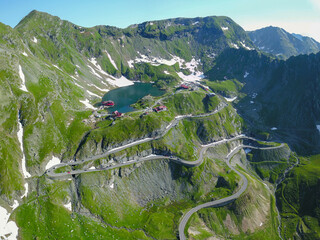 Aerial View of Balea Lake  Cauldron, the sharp Fagaras Mountains and the Transfagarasan road that...