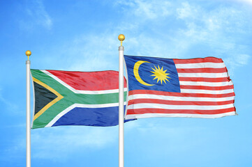 South Africa and Malaysia two flags on flagpoles and blue sky