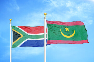 South Africa and Mauritania two flags on flagpoles and blue sky