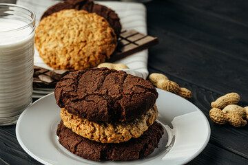 Chocolate and oat cookies on dark wooden table