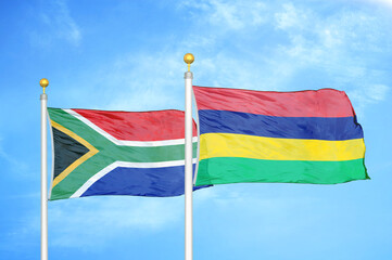 South Africa and Mauritius two flags on flagpoles and blue sky