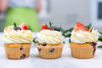 Fruit cupcakes on modern concrete background. Sweet baked pastry. Holidays cupcakes with fruit. Sweet cupcakes for party.