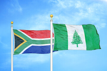 South Africa and Norfolk Island two flags on flagpoles and blue sky