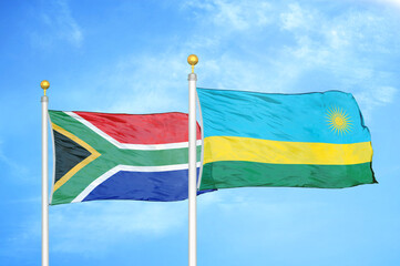 South Africa and Rwanda two flags on flagpoles and blue sky