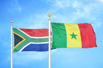 South Africa and Senegal two flags on flagpoles and blue sky