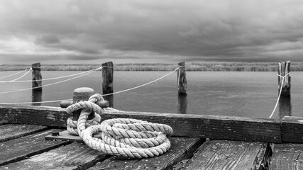 Naklejka premium Rope for mooring boats on a jetty.