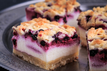 Homemade Blueberry Pie Bars. Delicious Crumble Bars on dark background.