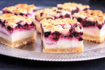 Homemade Blueberry Pie Bars. Delicious Crumble Bars on dark background.