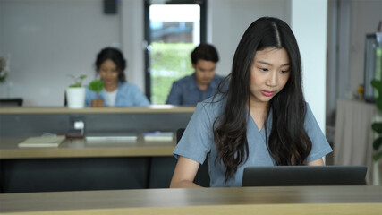 Business concepts. An Asian woman is typing within the office. 4k Resolution.