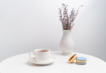 macarons on background Cup and vase with lavender.