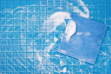 Blue rag in white foam on a blue background with cages