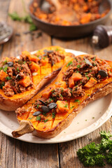 stuffed butternut squash half with minced meat and pumpkin seed