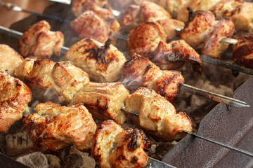 Meat kebabs on metal skewers. Grill on charcoal. Close-up, selective fokus.