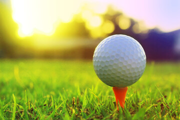 golf ball on tee in a beautiful golf course with morning sunshine