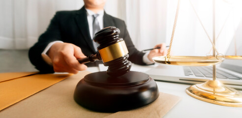 Business and lawyers discussing contract papers with brass scale on desk in office. Law, legal services, advice, justice and law concept picture with film grain effect