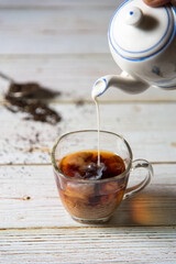 Milk pouring in tea cup