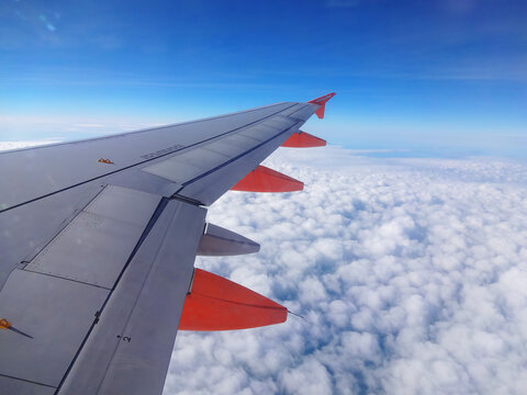London, UK, March 15, 2014 : EasyJet jet aeroplane flying above the clouds in mid air on it's way to a holiday airplane destination stock photo