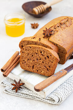 Spicy honey cake with cinnamon and anise star on grey concrete background. Honey cake for Rosh Hashanah.