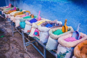 Blue town in Morocco, Chefchaouen. Famous blue city in north africa. Colorful spices and natural dyes on the market, bazaar. 